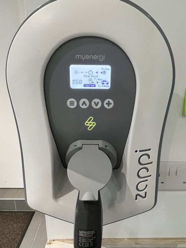 White myenergi zappi EV charger charging a car at 7.4kW in a garage, installed by AK Electrical